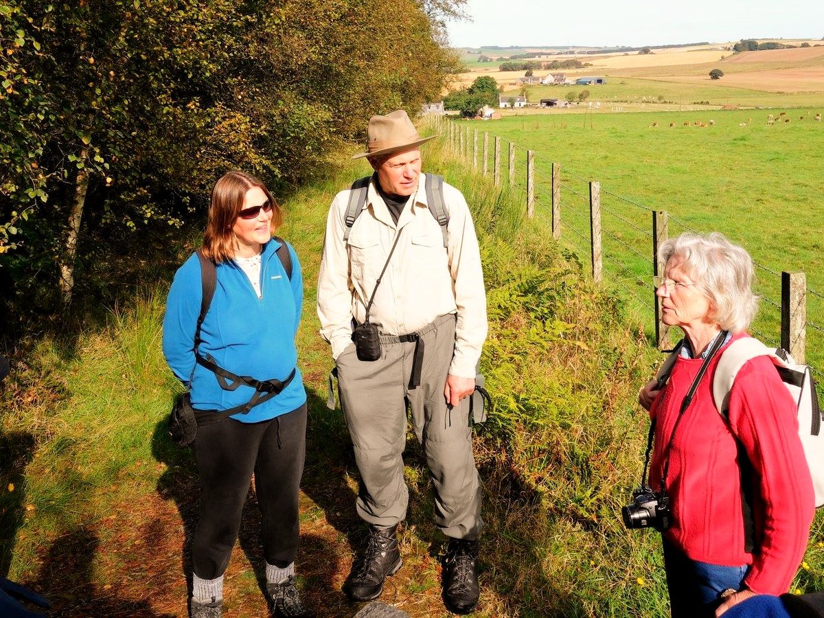 Three volunteers on a walk above the farmland at Woodhead